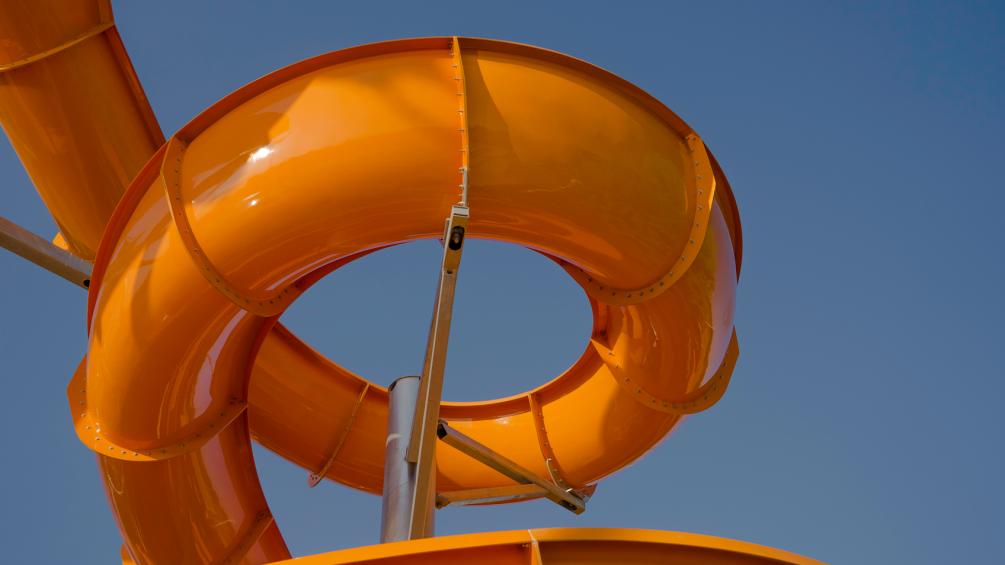 orange water slide set against blue sky